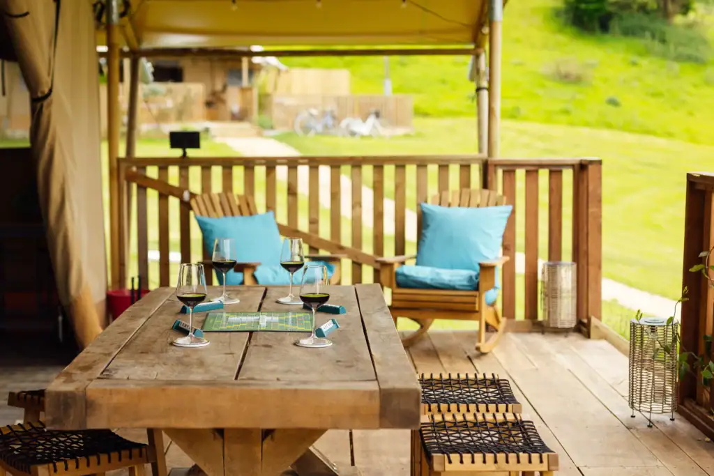 Outdoor decking and seating area at Horsecombe Lodge with views across Somerset countryside