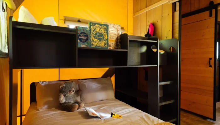 Family bedroom in Grisway Lodge with double bed and single bunk above for children