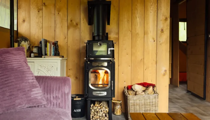 Wood burner inside Horsecombe Lodge creating a warm and cosy glamping space