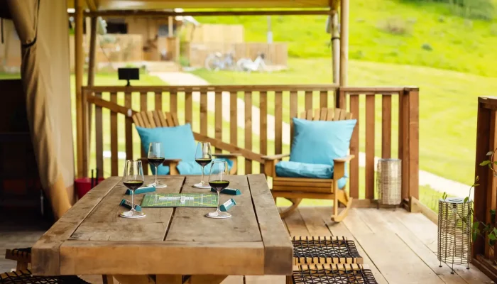 Outdoor decking and seating area at Horsecombe Lodge with views across Somerset countryside