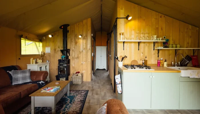 Fully equipped kitchen inside Lime Kiln Lodge safari tent with hob and utensils